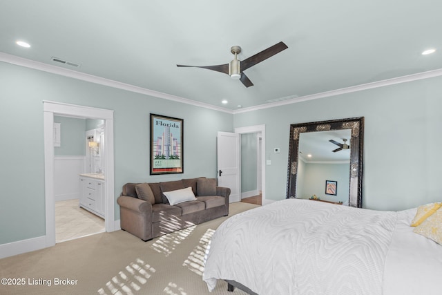 carpeted bedroom with ornamental molding, connected bathroom, and ceiling fan