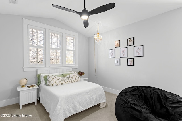 carpeted bedroom with ceiling fan and vaulted ceiling