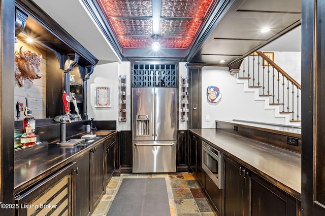 kitchen featuring stainless steel appliances, sink, wine cooler, and dark brown cabinetry