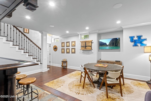 dining room with crown molding and wood-type flooring