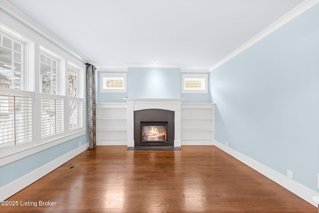 unfurnished living room featuring wood-type flooring and ornamental molding