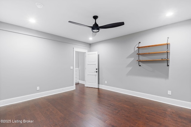 empty room featuring dark wood-type flooring and ceiling fan