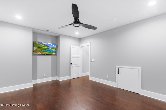 spare room featuring dark hardwood / wood-style floors and ceiling fan