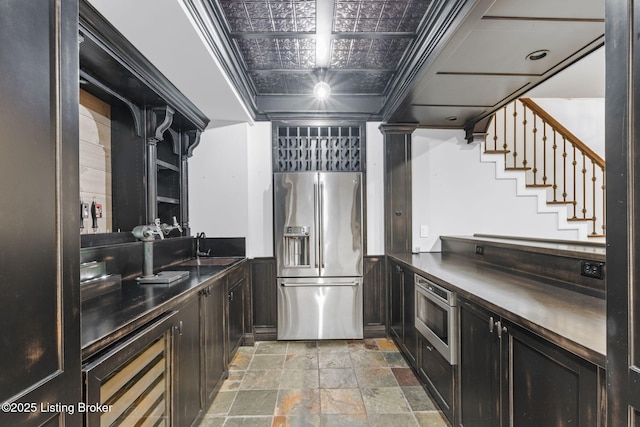 kitchen featuring sink, stainless steel appliances, and ornate columns