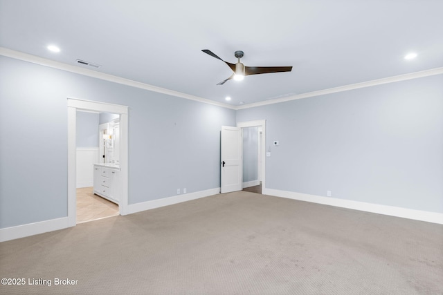 unfurnished bedroom featuring crown molding, connected bathroom, light colored carpet, and ceiling fan