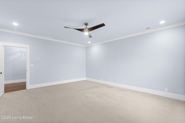 carpeted spare room featuring crown molding and ceiling fan