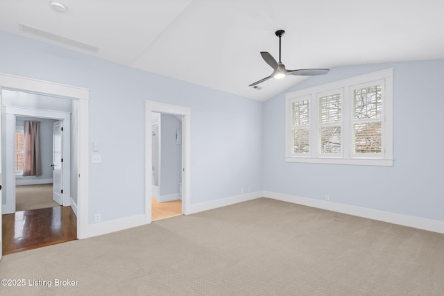 unfurnished bedroom featuring ceiling fan, lofted ceiling, and light carpet