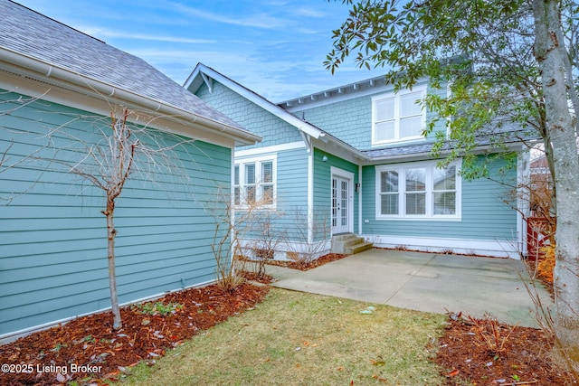 rear view of house with a yard and a patio area