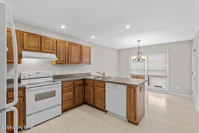 kitchen with kitchen peninsula, white appliances, sink, decorative light fixtures, and a chandelier