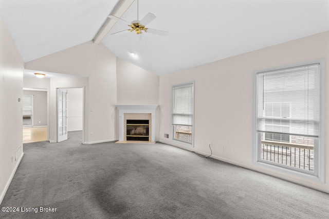 unfurnished living room with carpet, vaulted ceiling with beams, ceiling fan, and a tiled fireplace