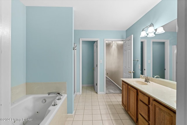 bathroom featuring tile patterned floors, vanity, and a tub to relax in