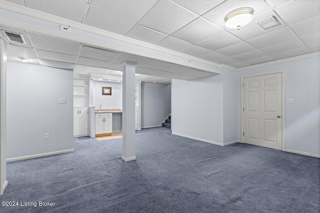 basement featuring carpet flooring and crown molding