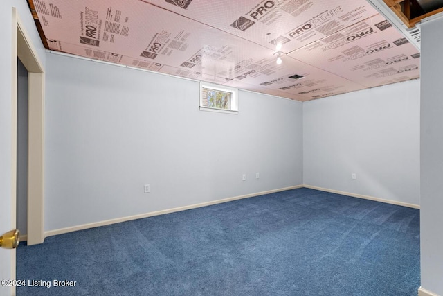 empty room featuring dark colored carpet