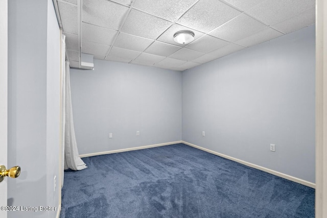 carpeted spare room with a paneled ceiling