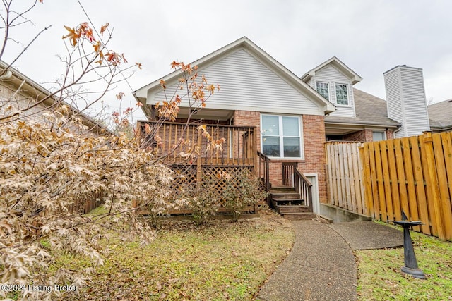 back of house with a wooden deck