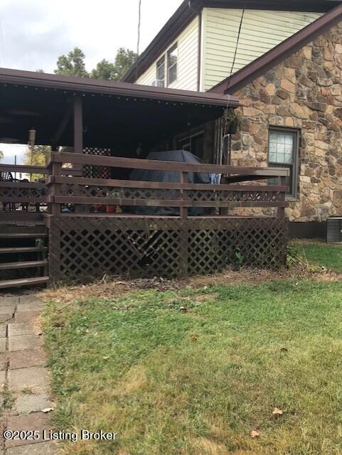 view of property exterior featuring a deck and a yard