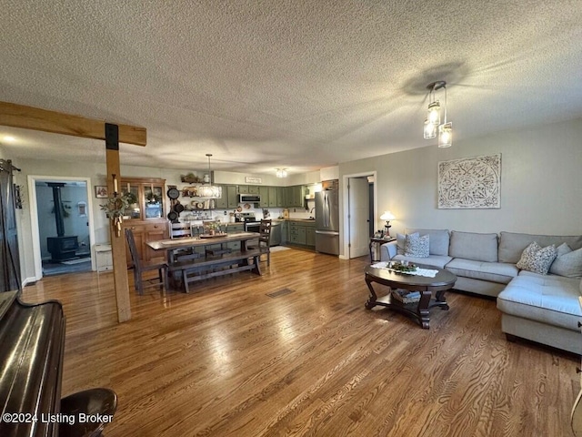 living room with wood-type flooring and a textured ceiling