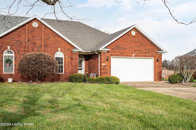 view of front of home featuring a garage and a front lawn