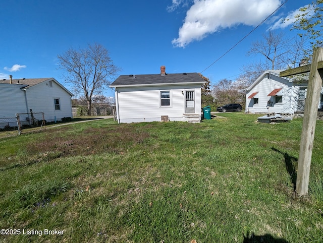 back of property with a lawn