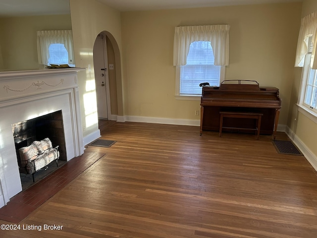 unfurnished living room featuring hardwood / wood-style floors and a wealth of natural light