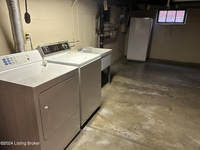 clothes washing area with washer and clothes dryer