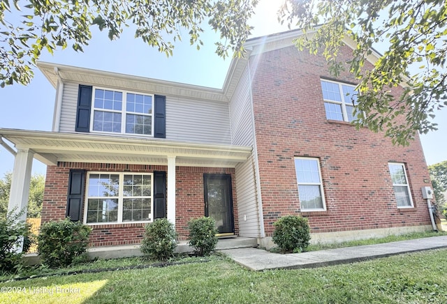 view of front of home featuring a front yard and a porch