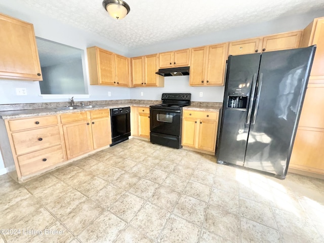 kitchen with light brown cabinetry, sink, black appliances, and a textured ceiling