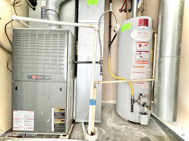 utility room with heating unit and gas water heater