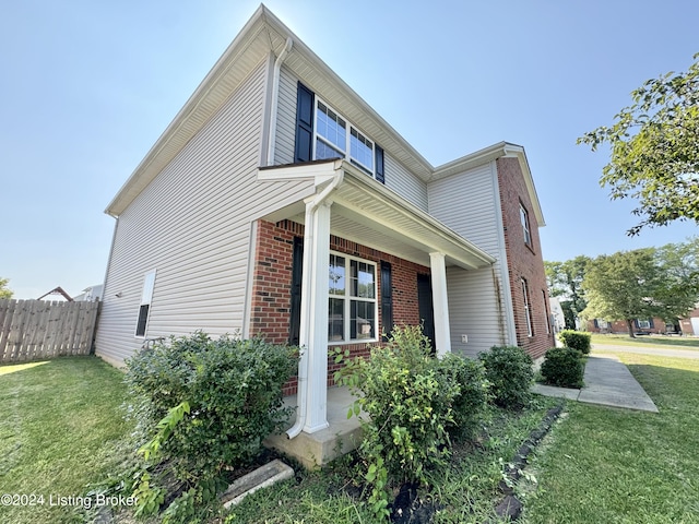 view of side of home featuring a yard