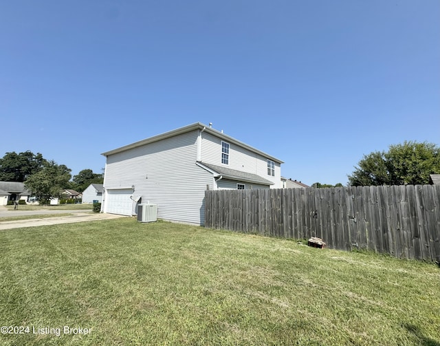 view of home's exterior with a lawn and central AC