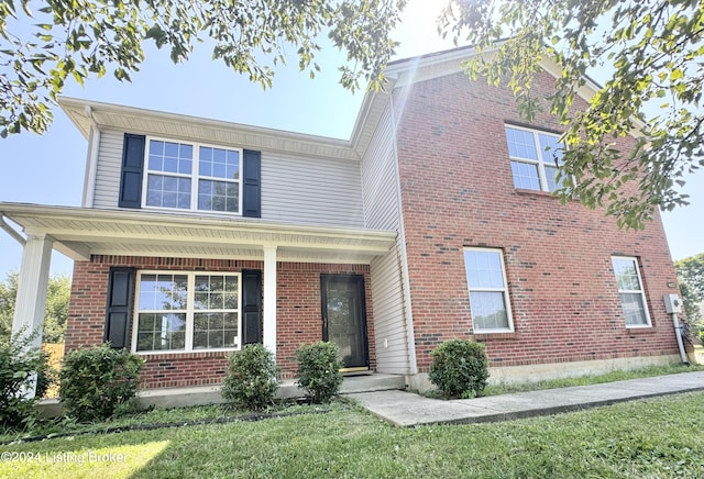 view of front of house featuring covered porch and a front yard