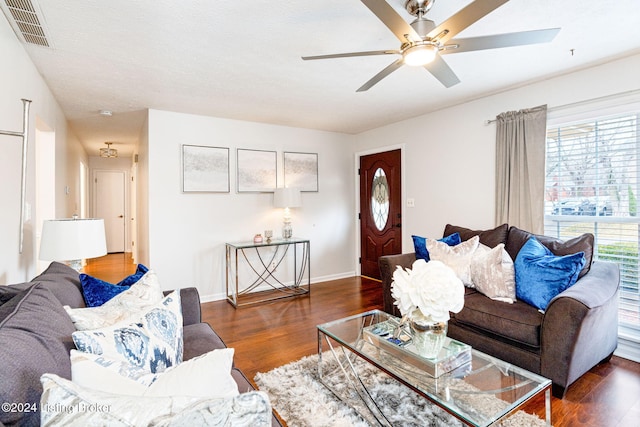 living room featuring ceiling fan and dark hardwood / wood-style floors