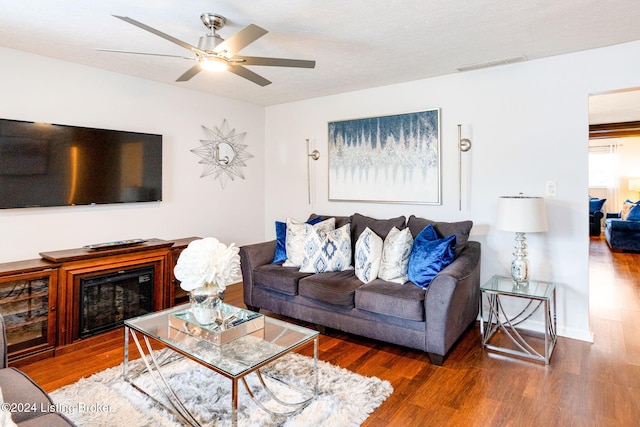 living room featuring dark hardwood / wood-style floors and ceiling fan