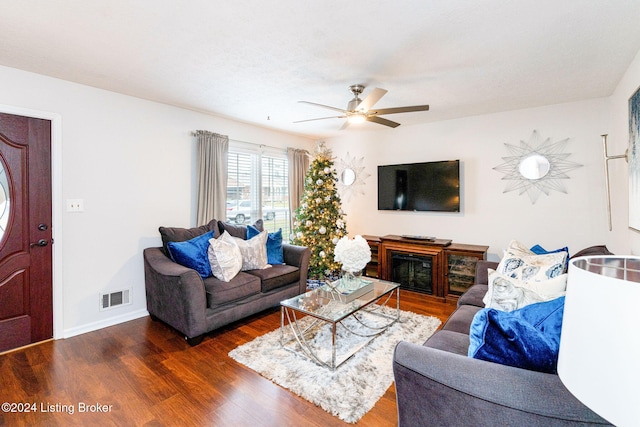 living room with ceiling fan and dark hardwood / wood-style floors