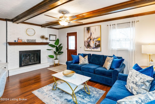 living room featuring dark hardwood / wood-style flooring, a brick fireplace, plenty of natural light, and ornamental molding