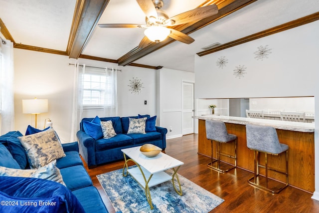 living room with beam ceiling, ceiling fan, dark wood-type flooring, and ornamental molding