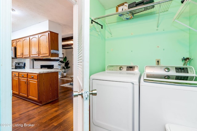 washroom featuring dark wood-type flooring and independent washer and dryer