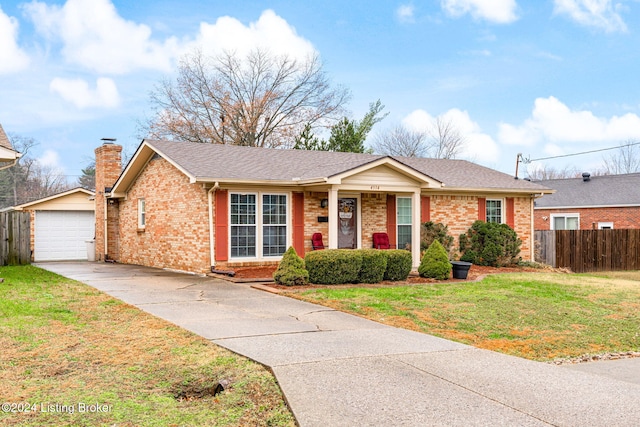 ranch-style house featuring an outbuilding, a front lawn, and a garage