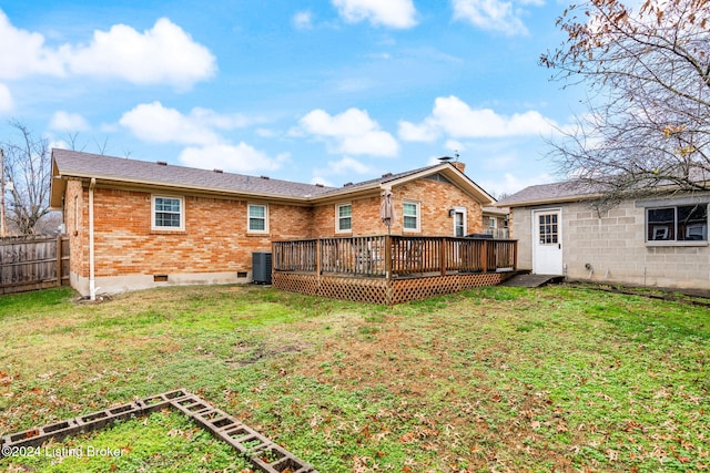 back of property with central AC unit, a lawn, and a wooden deck