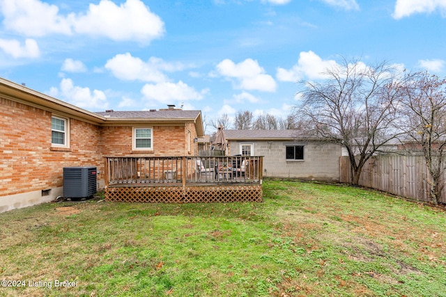 rear view of house featuring central air condition unit, a yard, and a deck