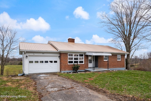 ranch-style home with a garage and a front lawn