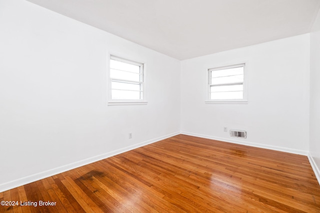 spare room featuring hardwood / wood-style flooring and a wealth of natural light