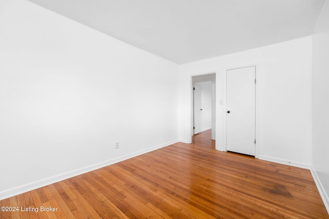 spare room with hardwood / wood-style flooring