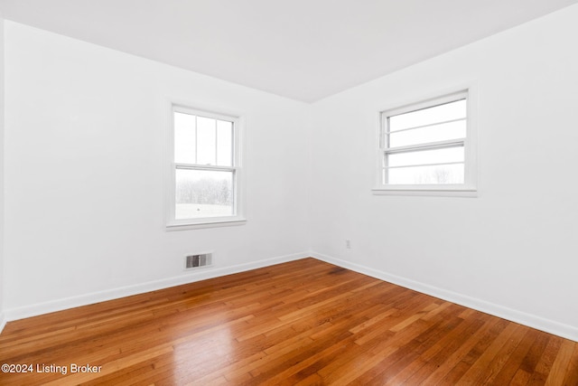 empty room with hardwood / wood-style flooring