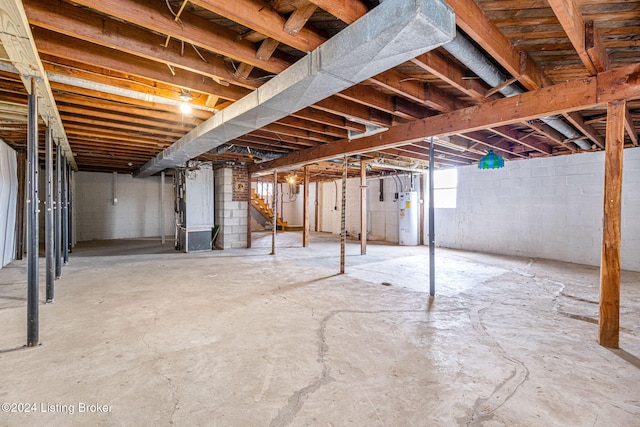 basement featuring heating unit and water heater