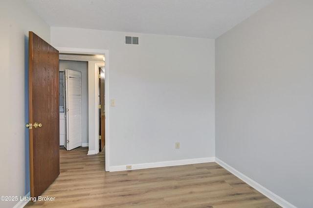 spare room featuring light wood-type flooring