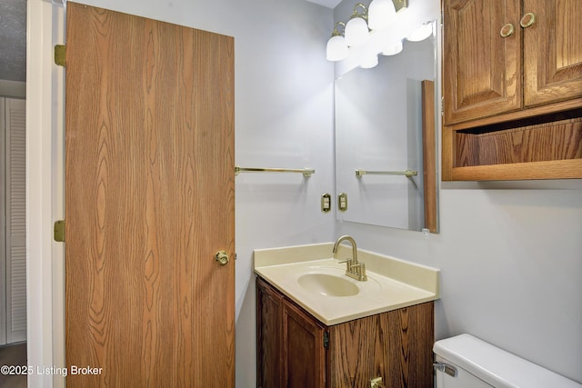 bathroom featuring vanity and toilet