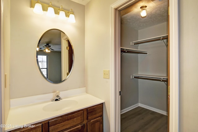 bathroom featuring vanity, hardwood / wood-style flooring, and a textured ceiling