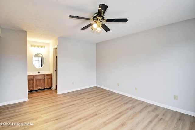 unfurnished bedroom with ceiling fan, light hardwood / wood-style floors, and ensuite bath