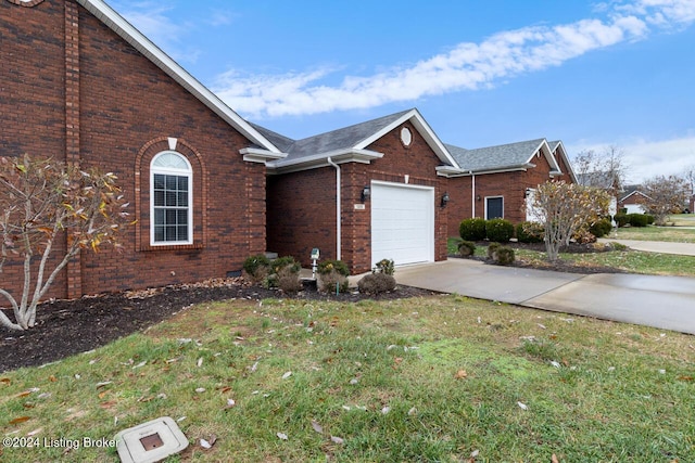 view of front of property with a garage and a front lawn